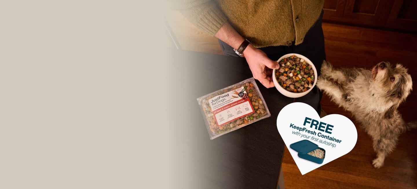 picture of a man holding a dog and bowl of food