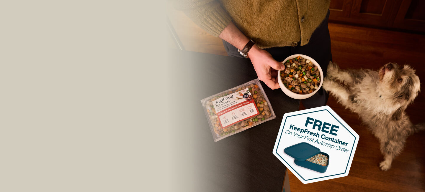 picture of a man holding a dog and bowl of food