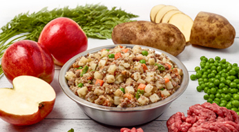 A bowl of our beef and russet potato recipe with fresh ingredients displayed around the bowl. 