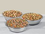 just food for dogs beef and russet potato, turkey and whole wheat macaroni, and large breed support meal presented in silver bowls. 