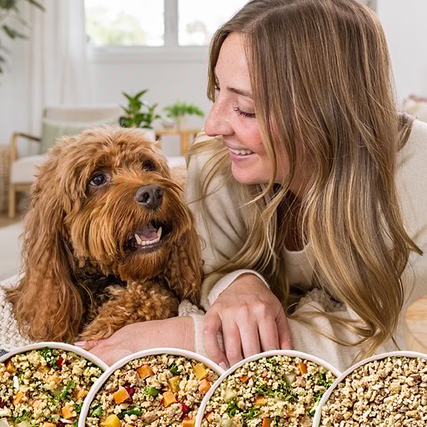woman and dog with four fresh food options