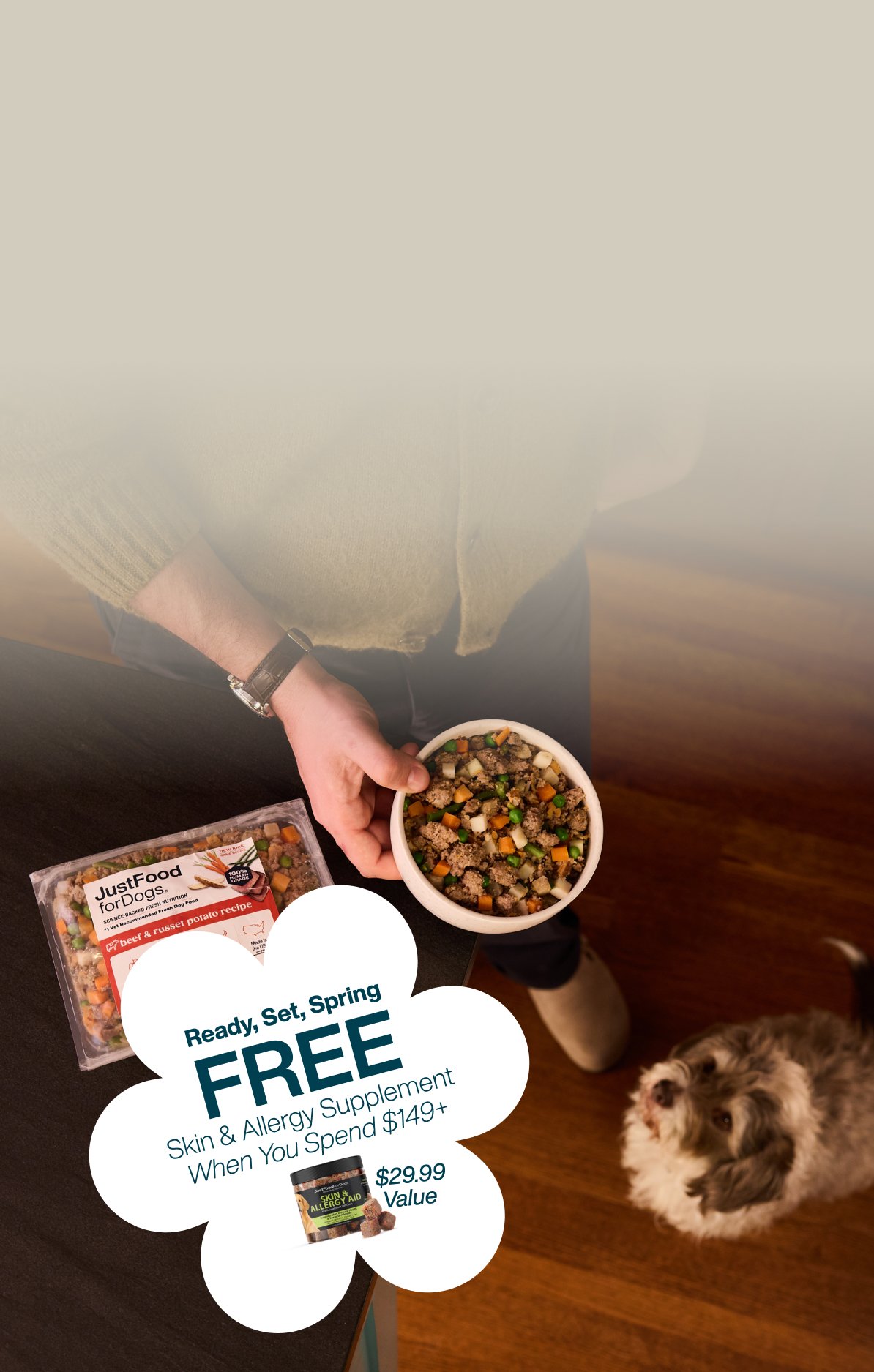 picture of a man holding a dog and bowl of food